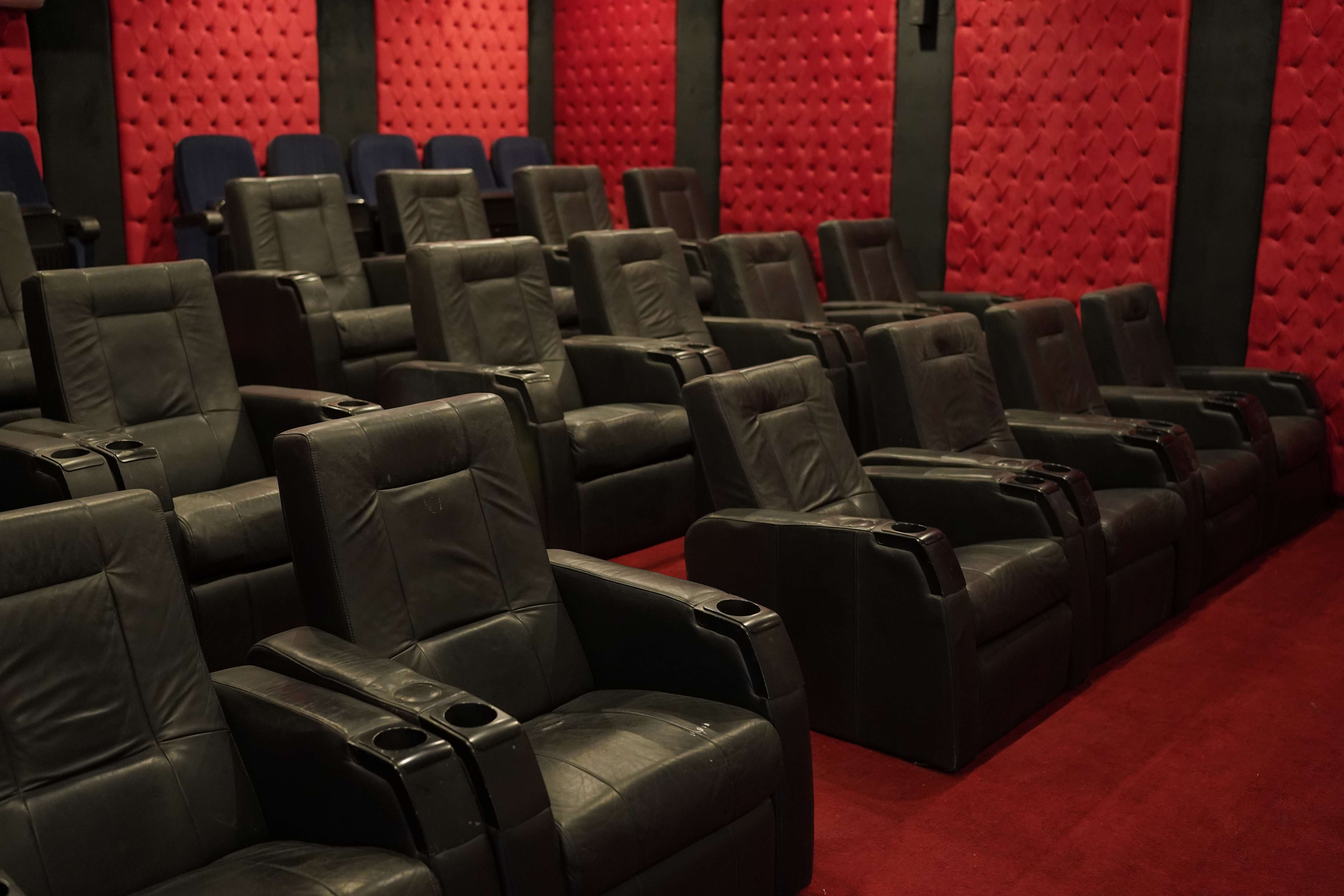 Private cinema with leather recliners and red velvet walls